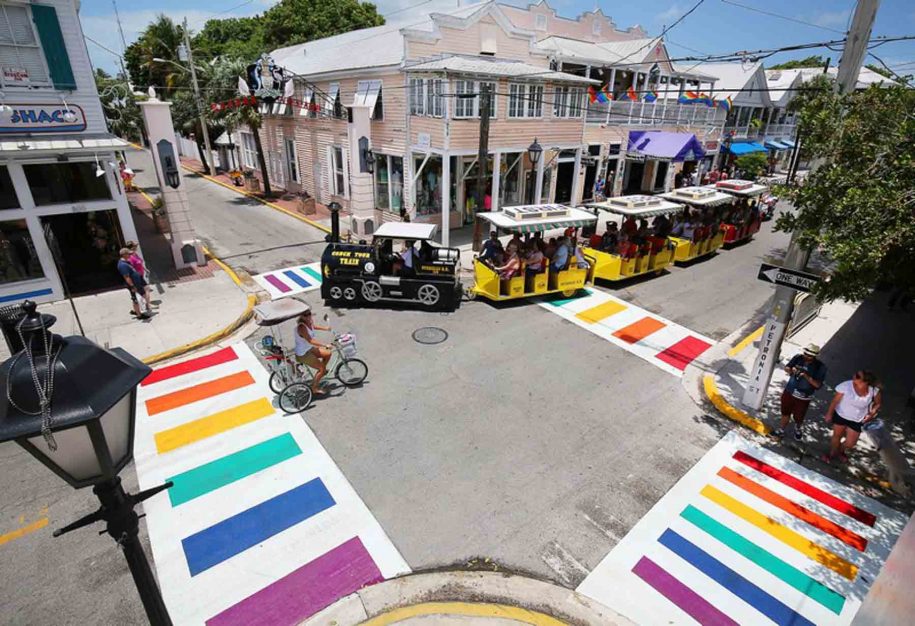 A View of the famous rainbow triangle crosswalks with a Conch tour train passing by.