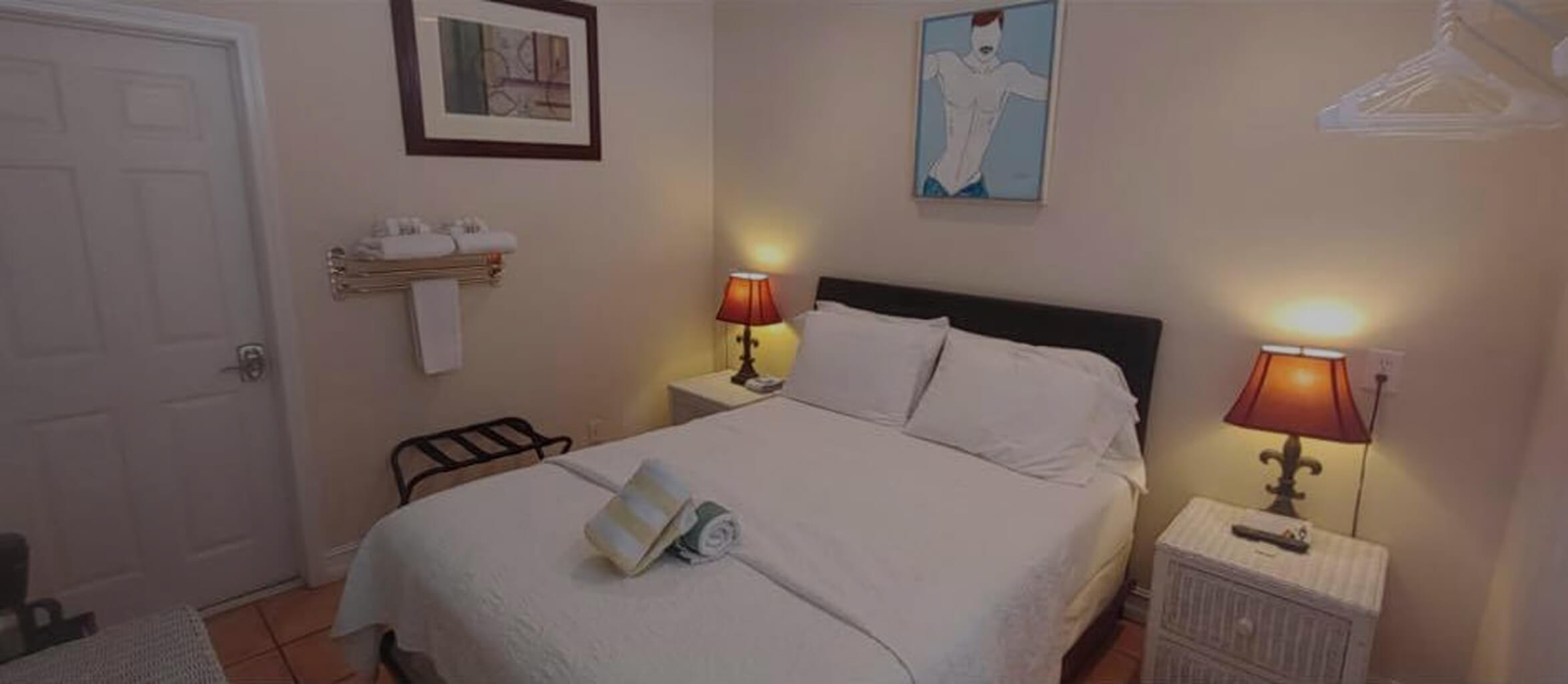 Room 23A with queen size bed and twin bedstands.