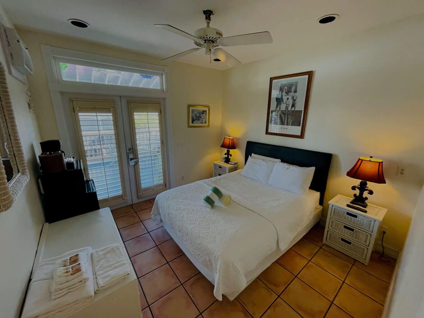 Room 22 with a queen size bed and French doors opening onto the grand balcony overlooking Duval Street