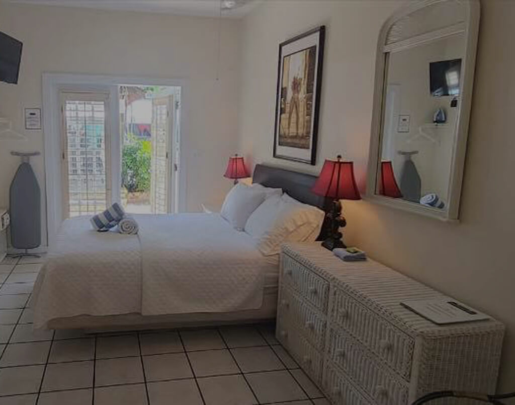 Room 12 with Queen bed and double door to garden bar area on first floor