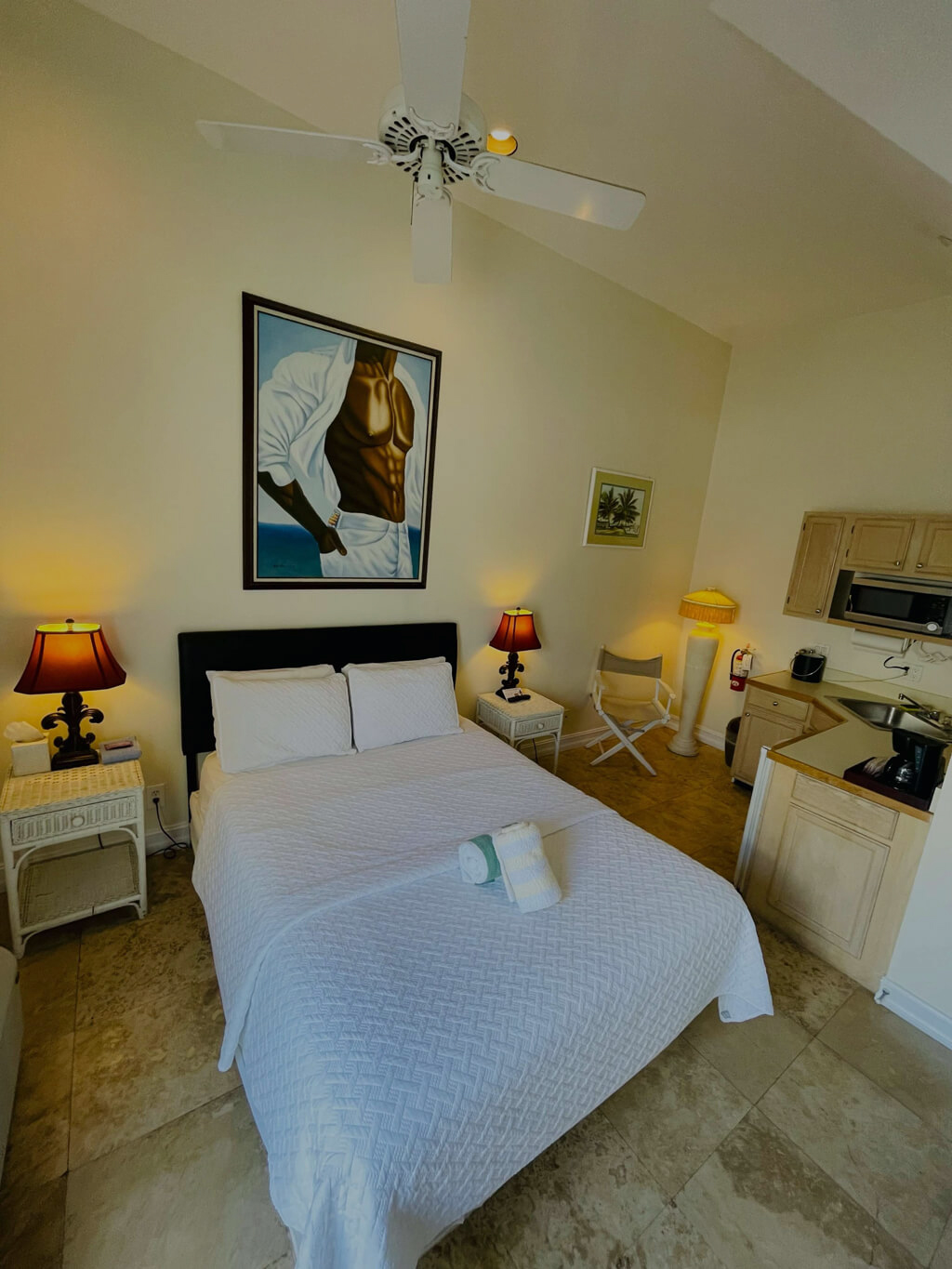 Room 25, a view of the queen size bed and kitchenette.