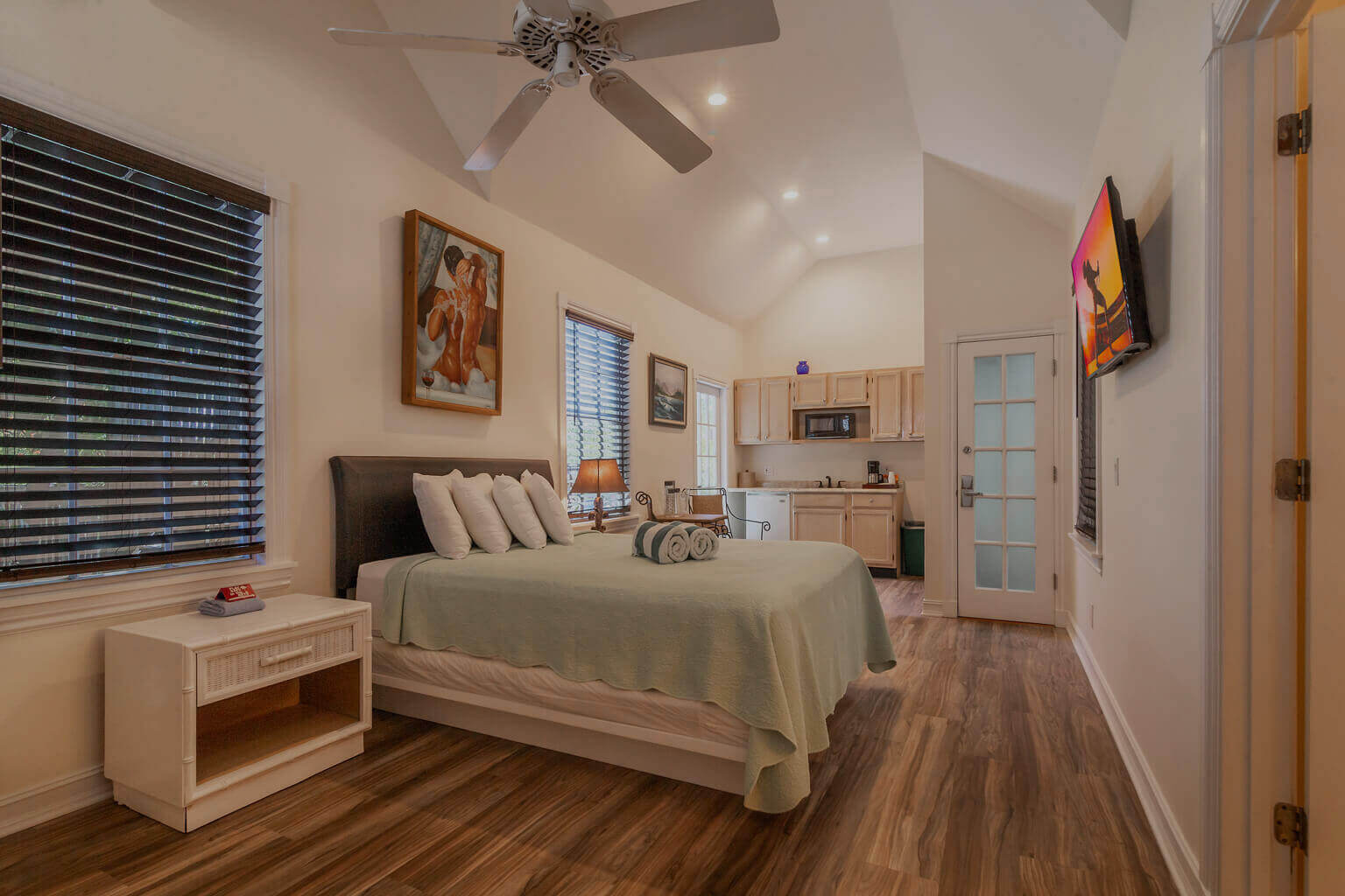 Room 26, a view of the queen size bed, kitchenette and door to the sundeck.