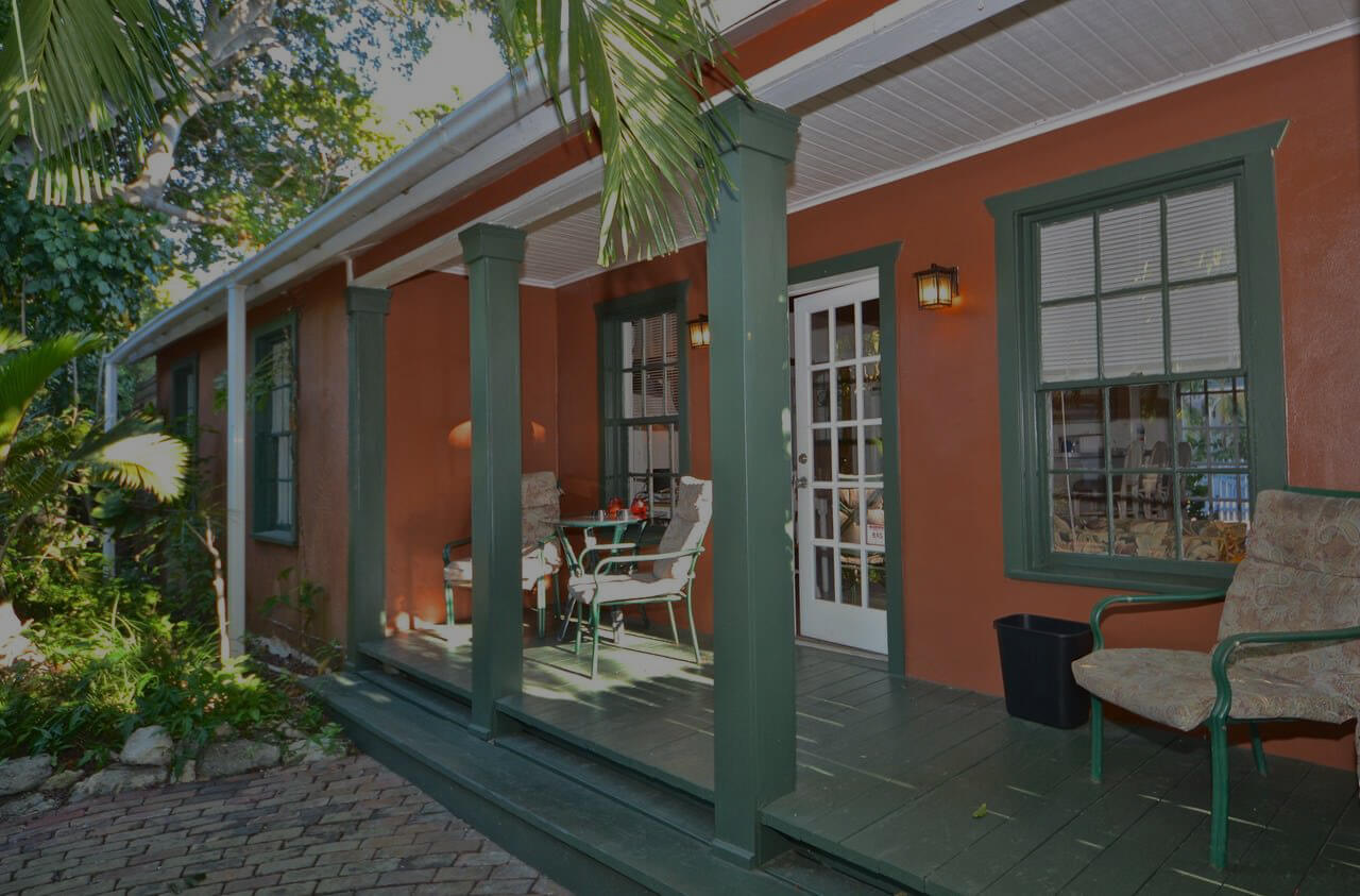 Private Cottage, a view of the outdoor deck with a table and two chairs.